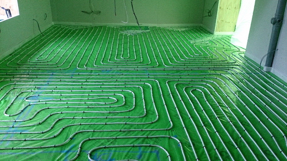 A moisture barrier is required to keep the floor screed separated from the foiled insulation.  Otherwise the screed will dissolve the aluminium foil.  This is also known as separation layer and vapour barrier.